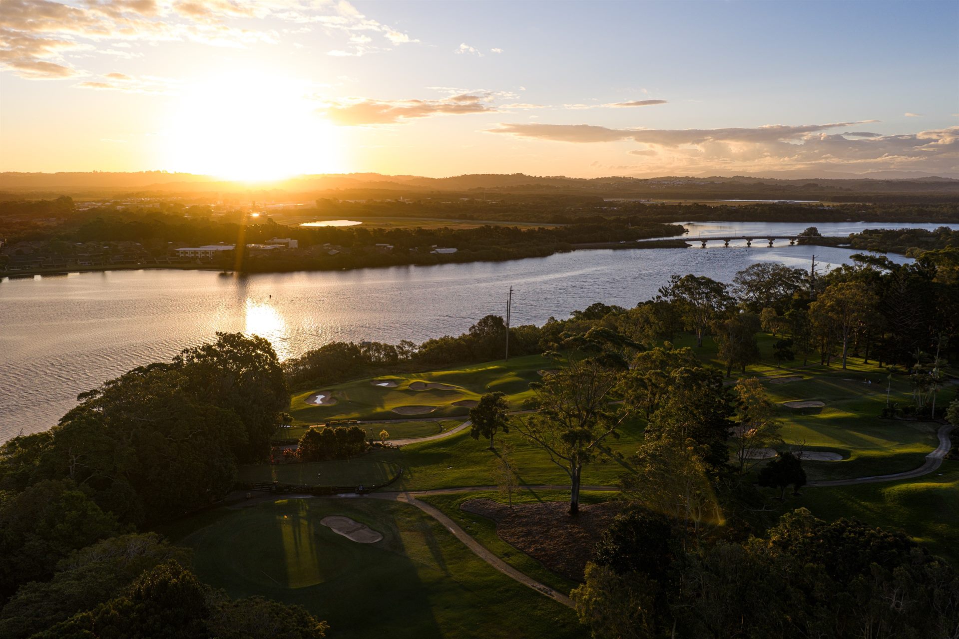 Golden-hour aerial view over Ballina Golf & Sports Club and the Richmond River