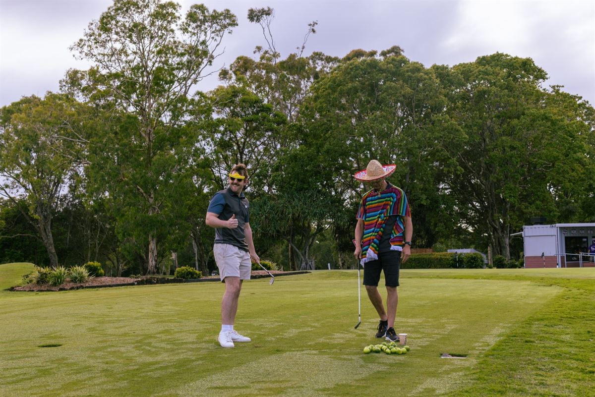 Two players in costume on the putting green