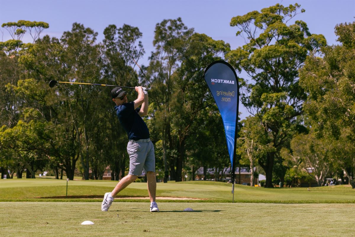 A player mid-swing teeing off