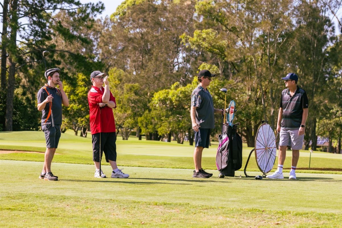 A group of players waiting on the tee